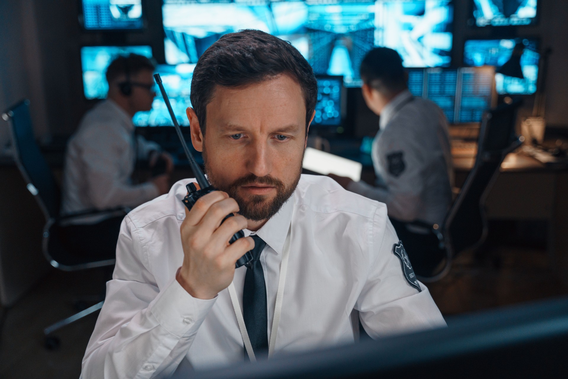 Portrait of a man who urgently transmits information using his walkie-talkie.