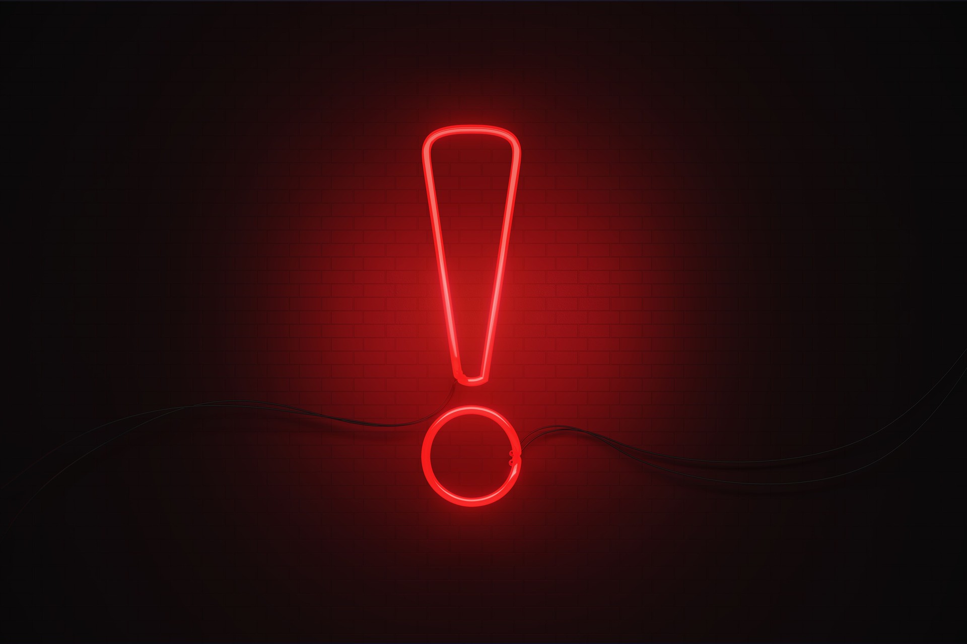 Exclamation Point Symbol Drawn by Red Neon Light on Black Wall